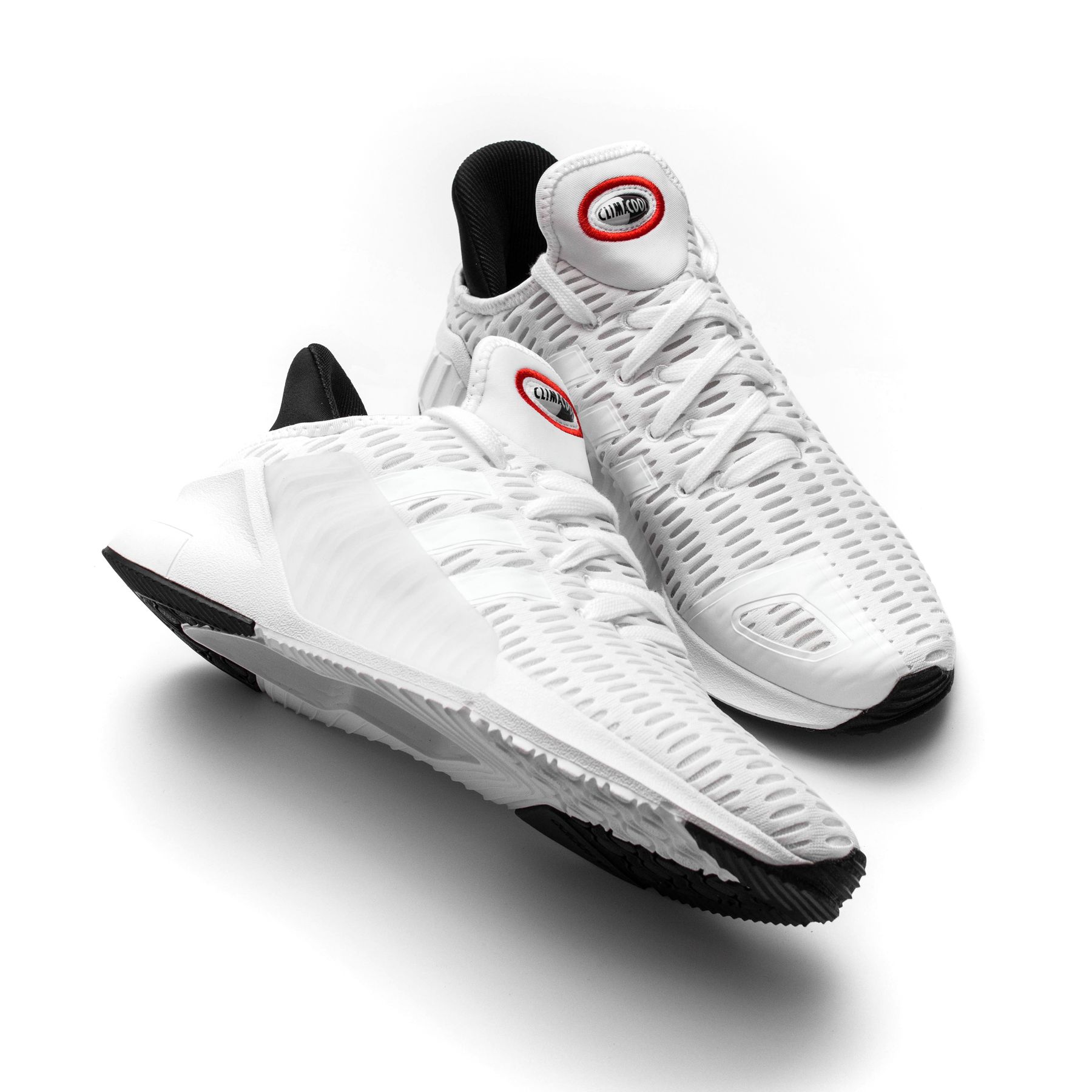 White sneakers with visible mesh and sole details